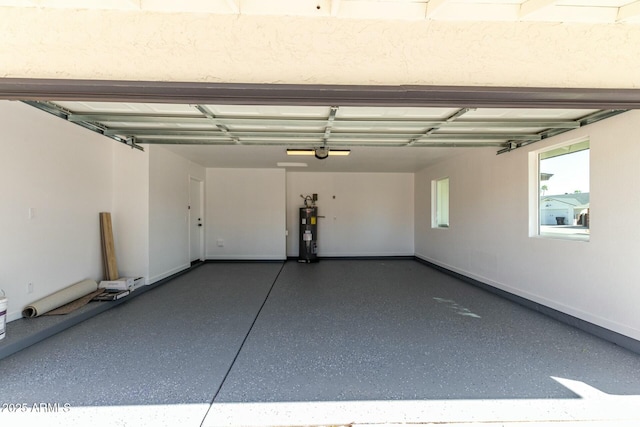 garage featuring electric water heater and a garage door opener