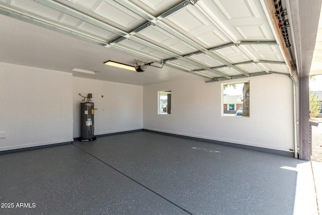 garage with baseboards, a garage door opener, and electric water heater