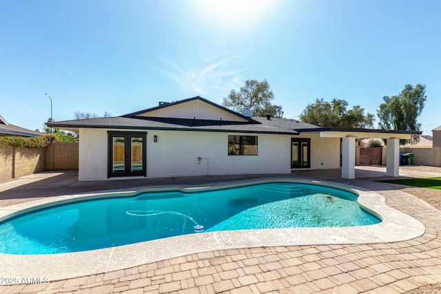 view of swimming pool with a fenced in pool, french doors, and a patio