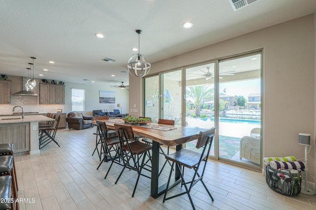 dining space with ceiling fan, recessed lighting, light wood-style flooring, and visible vents