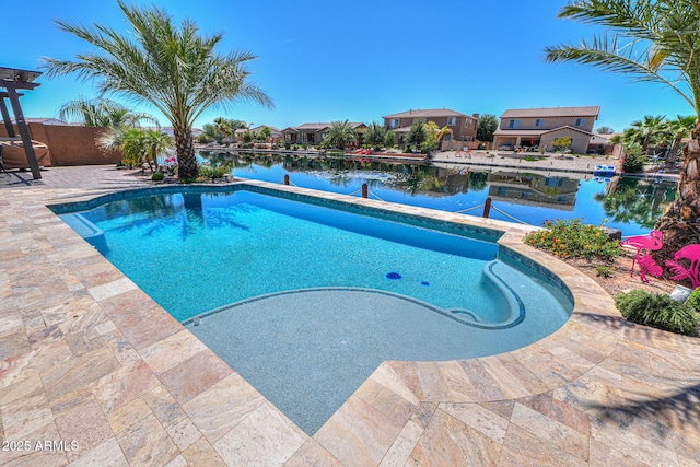 outdoor pool featuring a water view, fence, a residential view, and a patio area
