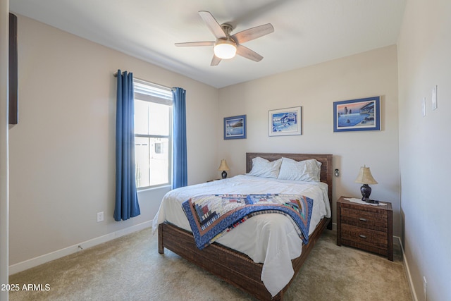 carpeted bedroom featuring baseboards and ceiling fan