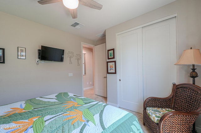 bedroom with a ceiling fan, light colored carpet, visible vents, baseboards, and a closet