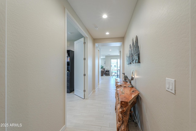 hallway with baseboards and recessed lighting