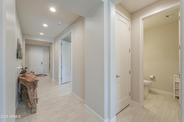 corridor featuring baseboards, recessed lighting, light wood-style flooring, and visible vents