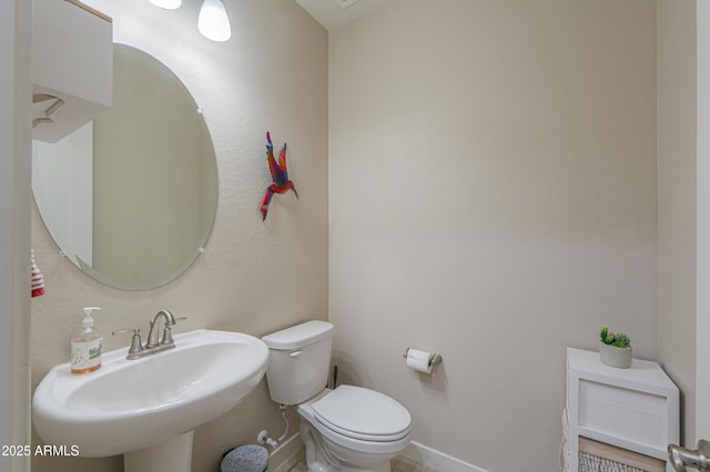 bathroom with toilet and a sink