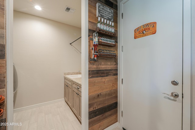 interior space featuring visible vents, recessed lighting, baseboards, and vanity