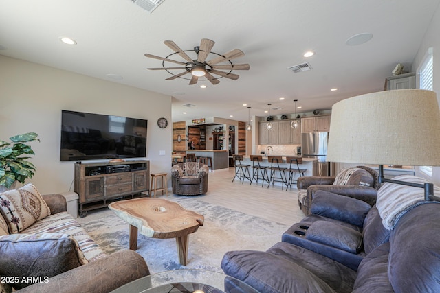 living room with visible vents, recessed lighting, light wood finished floors, and ceiling fan