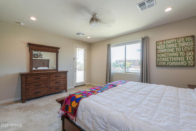 carpeted bedroom with visible vents, baseboards, and access to outside