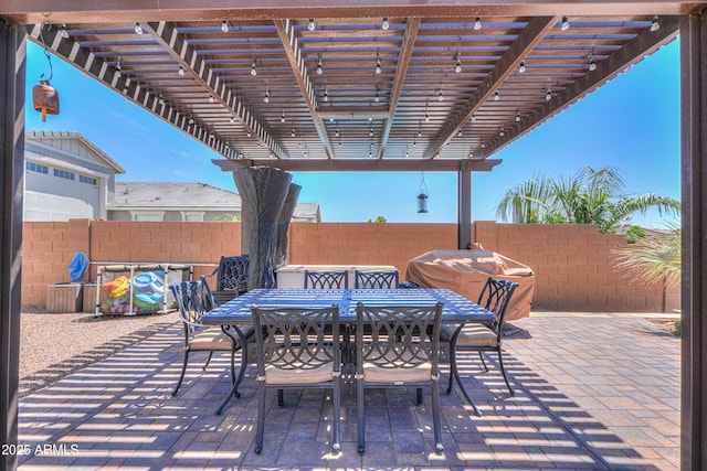 view of patio with fence, outdoor dining space, a pergola, and area for grilling