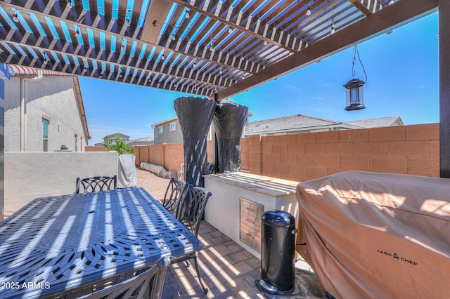 view of patio featuring outdoor dining area and fence
