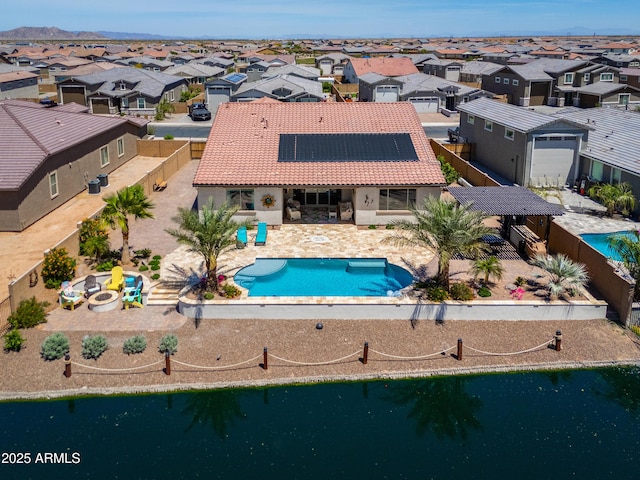 pool featuring a residential view, a fenced backyard, and a patio area