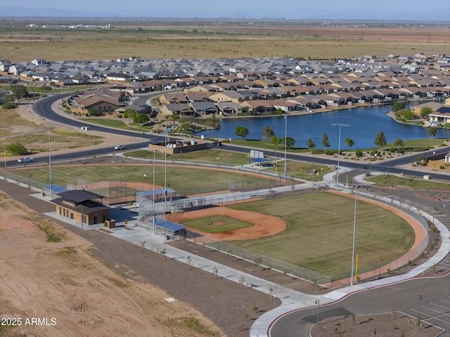 drone / aerial view featuring a water view and a residential view