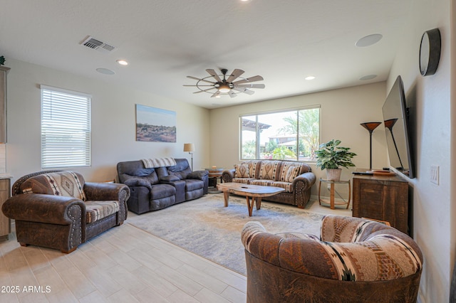 living room featuring visible vents, a ceiling fan, a healthy amount of sunlight, and recessed lighting