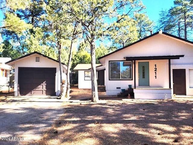 view of front of property featuring a garage and an outbuilding