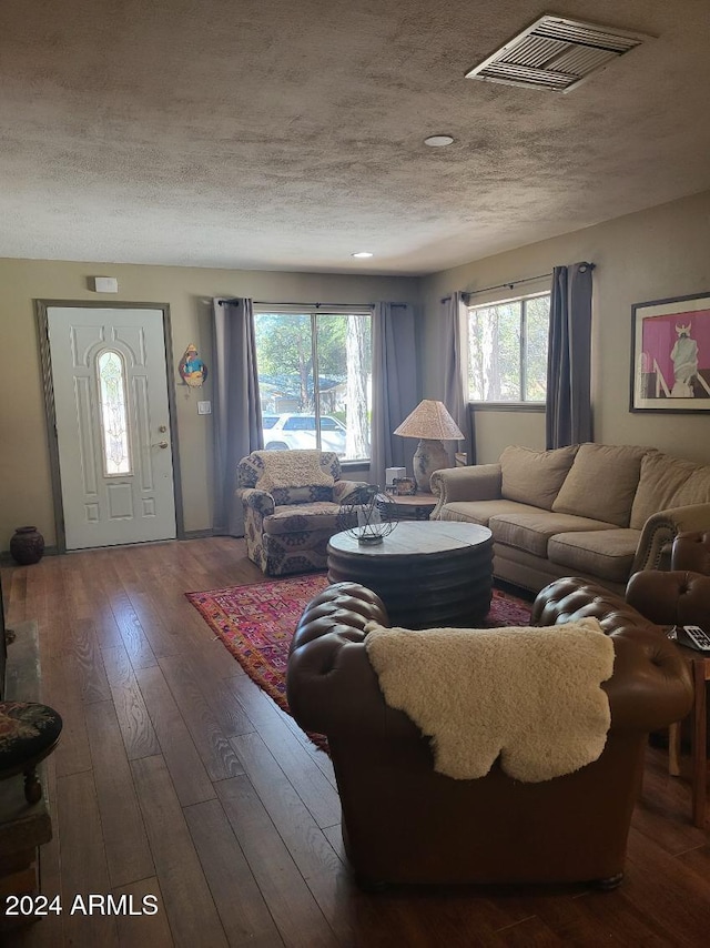 living room featuring a textured ceiling and hardwood / wood-style flooring