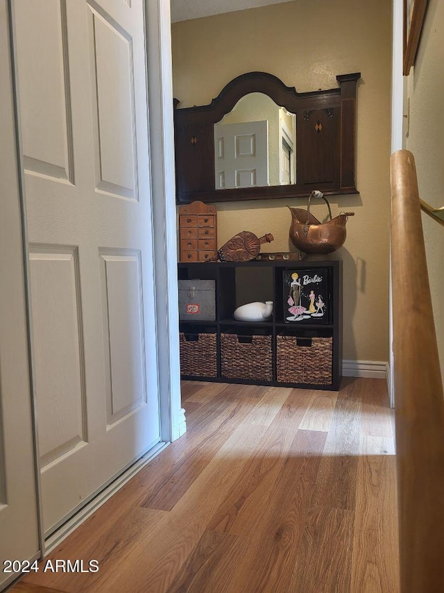 corridor with light hardwood / wood-style flooring