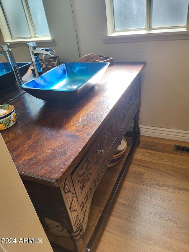 details featuring hardwood / wood-style floors and sink