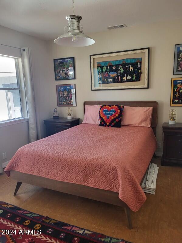 bedroom with wood-type flooring