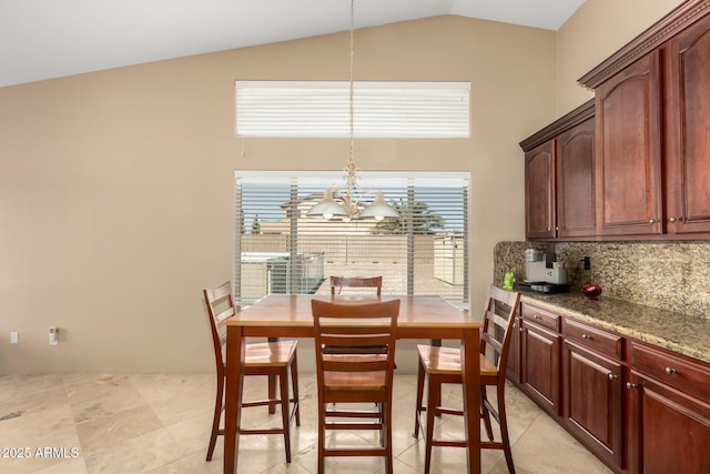 dining room featuring lofted ceiling and light tile patterned floors