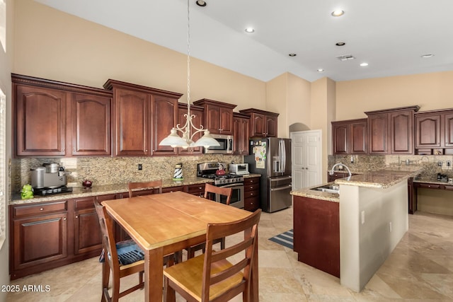 kitchen with a center island with sink, arched walkways, a high ceiling, stainless steel appliances, and a sink