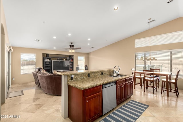 kitchen with reddish brown cabinets, plenty of natural light, visible vents, stainless steel dishwasher, and a sink