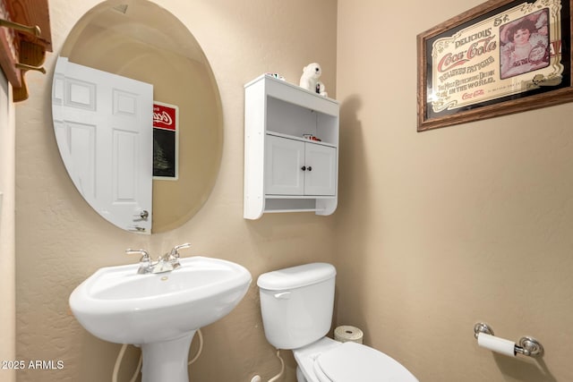 bathroom with toilet and a sink