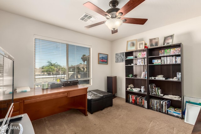 office space featuring carpet, visible vents, and ceiling fan