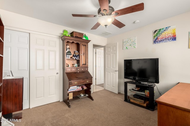 interior space with light colored carpet and ceiling fan