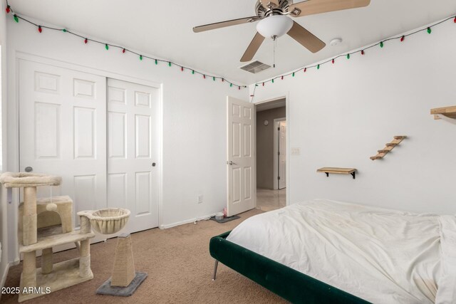 bedroom featuring a ceiling fan, carpet, visible vents, and a closet