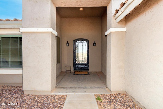 property entrance with stucco siding