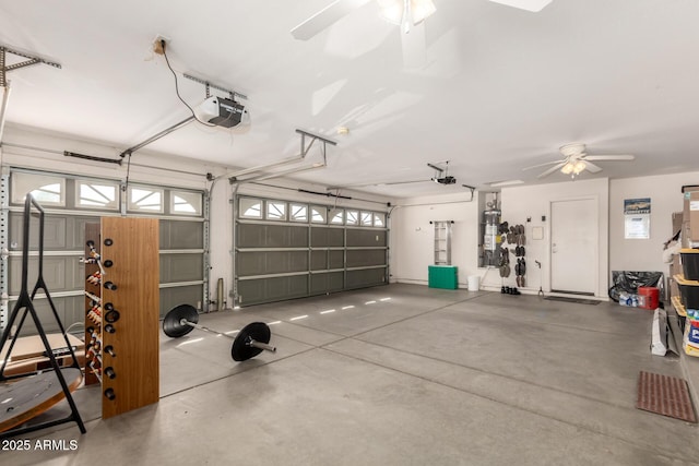 garage featuring a garage door opener, water heater, and a ceiling fan