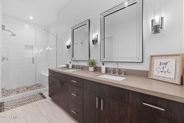bathroom featuring vanity and a shower with shower door