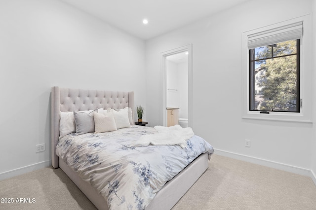 carpeted bedroom featuring connected bathroom
