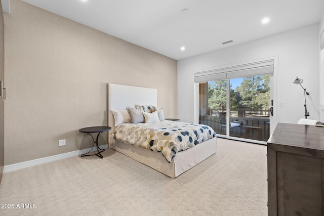 bedroom with access to outside and light colored carpet