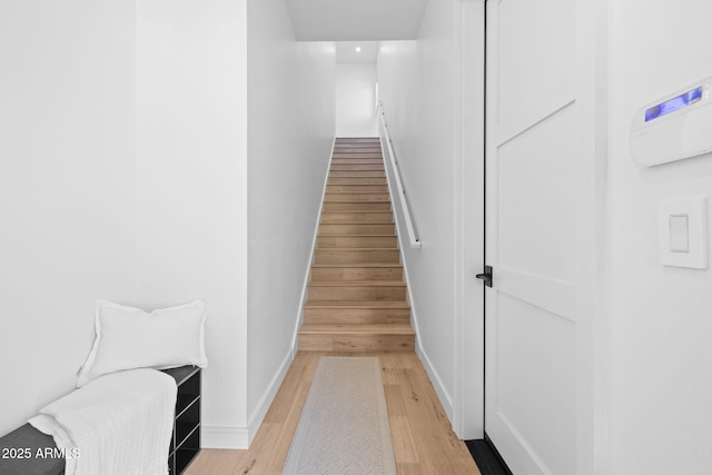 stairs with hardwood / wood-style floors