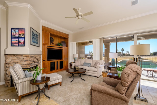 living room with built in shelves, ceiling fan, a fireplace, and ornamental molding