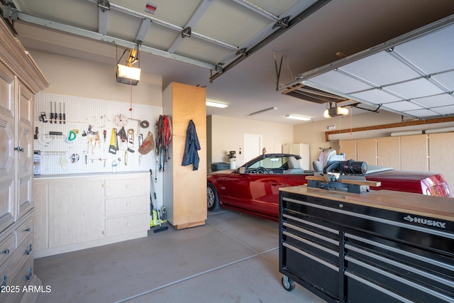 garage featuring a workshop area and a garage door opener