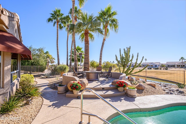 view of patio / terrace with a fenced in pool