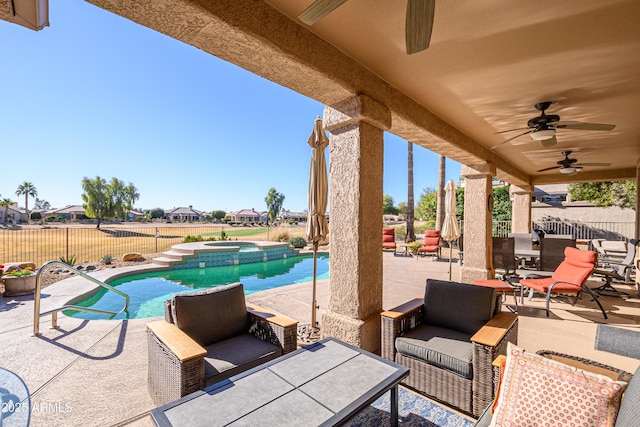 view of patio / terrace with ceiling fan and a swimming pool with hot tub