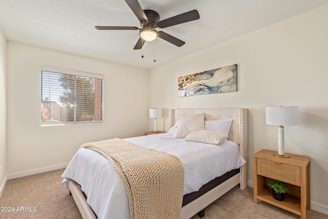 bedroom with light carpet, ceiling fan, and baseboards