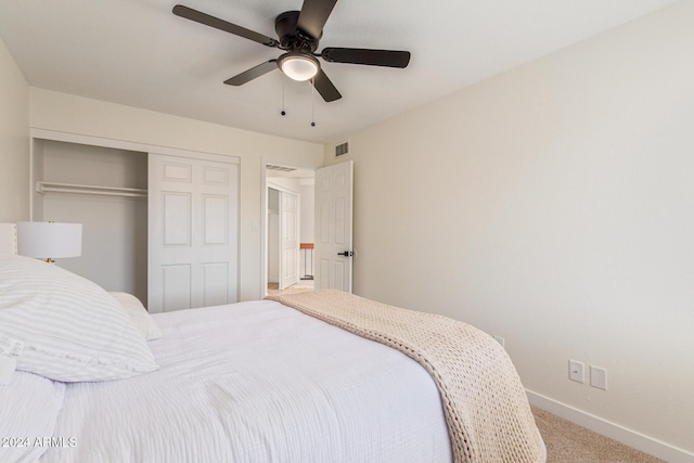 carpeted bedroom featuring a ceiling fan, a closet, visible vents, and baseboards