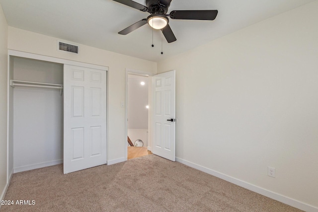 unfurnished bedroom with ceiling fan, carpet floors, visible vents, baseboards, and a closet