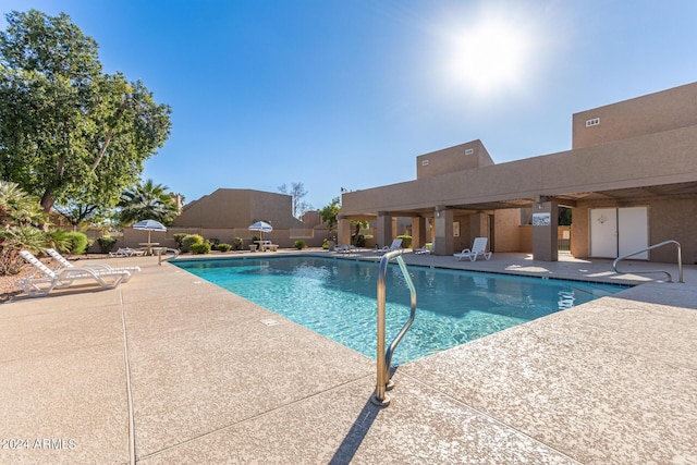 community pool with a patio area