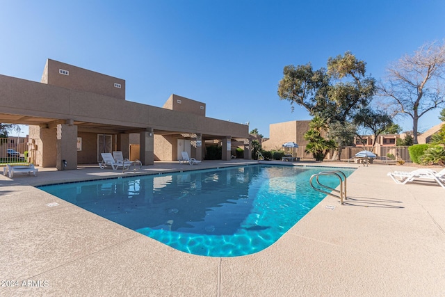 community pool featuring a patio area and fence