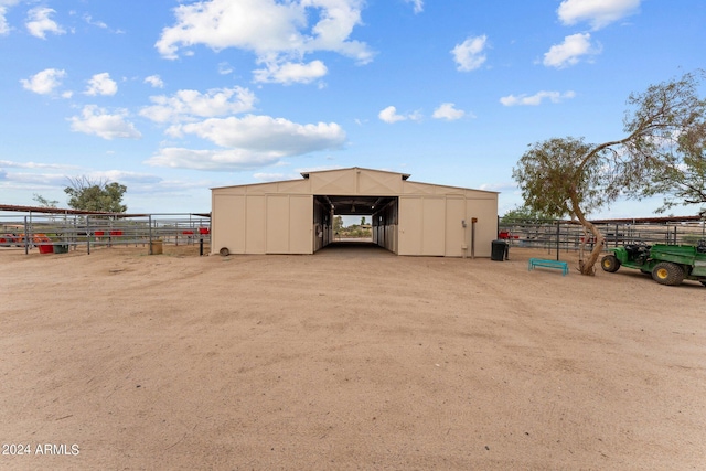 view of pole building featuring an exterior structure and fence