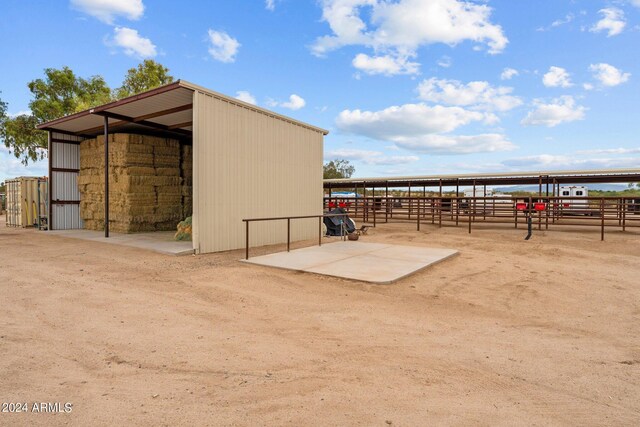 view of horse barn with an outdoor structure