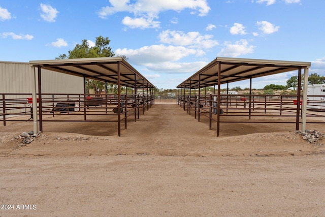 view of stable with a rural view and an outdoor structure