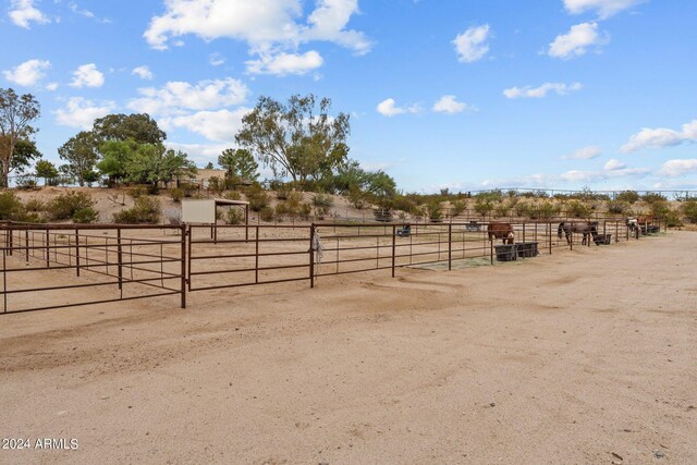 view of horse barn with a rural view