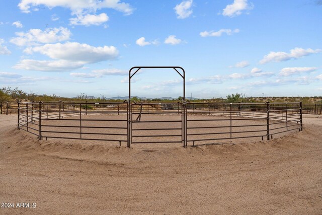 view of horse barn featuring a rural view